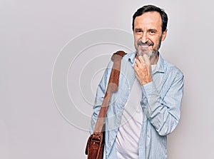 Middle age handsome businessman wearing leather bag over isolated white background smiling looking confident at the camera with