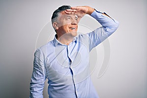 Middle age handsome grey-haired business man wearing elegant shirt over white background very happy and smiling looking far away