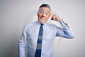 Middle age handsome grey-haired business man wearing elegant shirt and tie Smiling pointing to head with one finger, great idea or