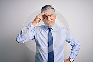 Middle age handsome grey-haired business man wearing elegant shirt and tie worried and stressed about a problem with hand on