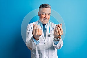 Middle age handsome grey-haired doctor man wearing coat and blue stethoscope doing money gesture with hands, asking for salary