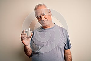 Middle age handsome hoary man drinking glass of water over isolated white background with a happy face standing and smiling with a