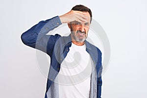 Middle age handsome man wearing blue denim shirt standing over isolated white background worried and stressed about a problem with