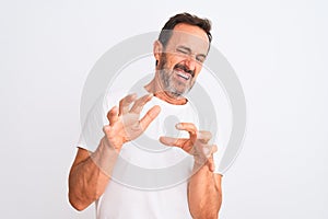 Middle age handsome man wearing casual t-shirt standing over isolated white background disgusted expression, displeased and