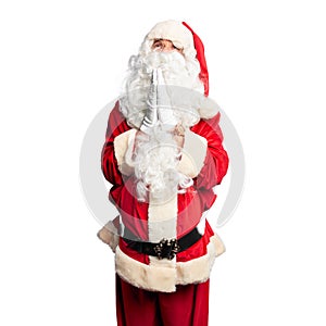 Middle age handsome man wearing Santa Claus costume and beard standing begging and praying with hands together with hope