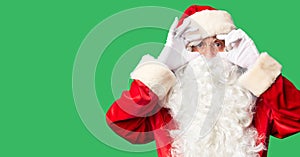 Middle age handsome man wearing Santa Claus costume and beard standing Trying to open eyes with fingers, sleepy and tired for