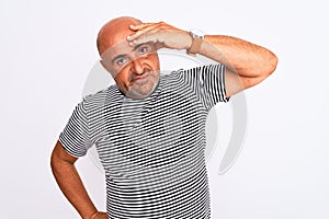 Middle age handsome man wearing striped navy t-shirt over isolated white background worried and stressed about a problem with hand