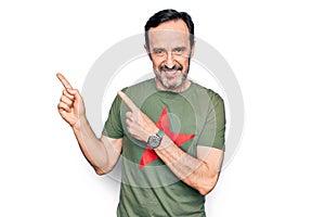 Middle age handsome man wearing t-shirt with revolutionary red star over white background smiling and looking at the camera