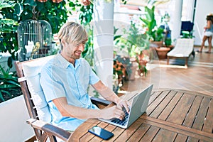 Middle age handsome man working at home using computer laptop