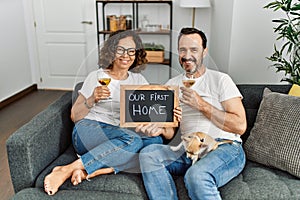 Middle age hispanic couple smiling happy toasting with champagne