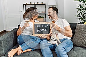 Middle age hispanic couple smiling happy toasting with champagne