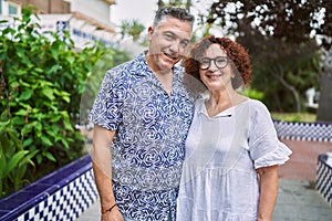 Middle age hispanic couple together outdoors on summer day