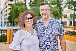 Middle age hispanic couple together outdoors on summer day