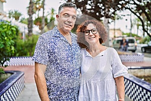 Middle age hispanic couple together outdoors on summer day