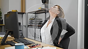 Middle age hispanic woman business worker suffering for backache at office