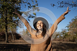 Middle age hispanic woman stretching arms breathing fresh air walking in autumn forest