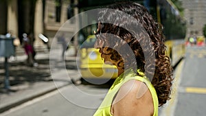 Middle age hispanic woman walking crossing pedestrian street at the street