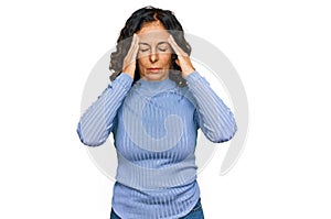 Middle age hispanic woman wearing casual clothes suffering from headache desperate and stressed because pain and migraine