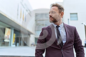 Middle age man business worker standing with serious expression at street