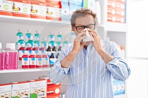 Middle age man customer using napkin at pharmacy