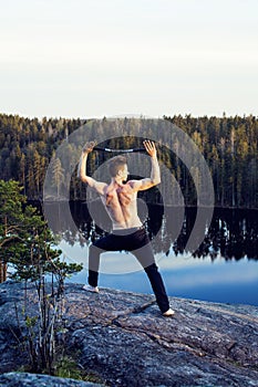 Middle age man doing sport yoga on the top of the mountain, lifestyle people outdoor, summer wild nature for training