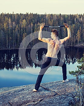 Middle age man doing sport yoga on the top of the mountain, lifestyle people outdoor, summer wild nature for training