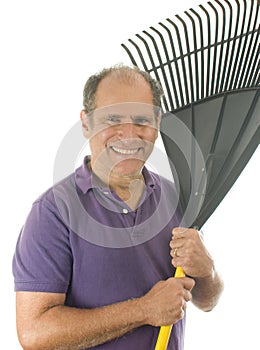 Middle age man holding garden leaf rake tool