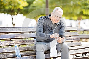 Middle age man listening music after workout