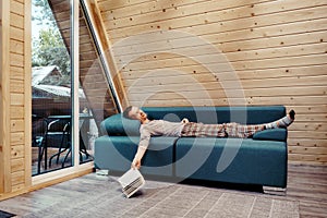 Middle age man is napping on the sofa in his country house