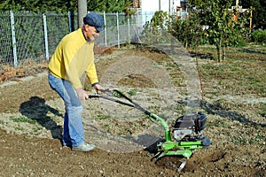 Middle age man with a rototiller