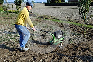 Middle age man with a rototiller