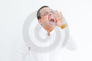 Middle age man shouting crazy with hands over mouth over white wall background