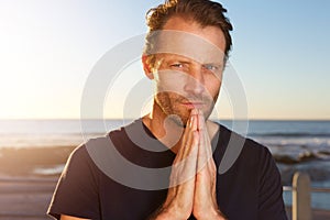 Middle age man staring with hands clasp