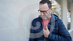 Middle age man suffering heart attack at street