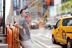 Middle age man tourist looking on Times Square on sunny summer day, downtown Manhattan, New York photo