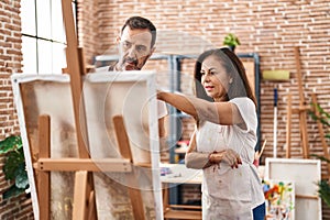 Middle age man and woman artists drawing at art studio
