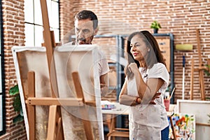 Middle age man and woman artists drawing at art studio