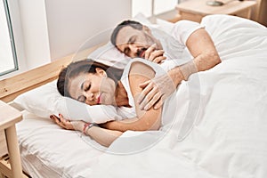 Middle age man and woman couple sleeping on bed at bedroom