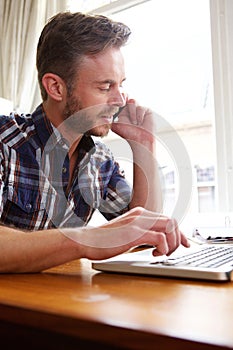 Middle age man working with laptop and smart phone