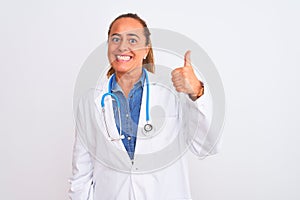 Middle age mature doctor woman wearing stethoscope over isolated background doing happy thumbs up gesture with hand