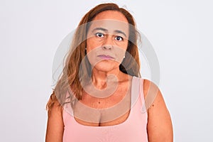 Middle age mature woman standing over white isolated background with a confident expression on smart face thinking serious