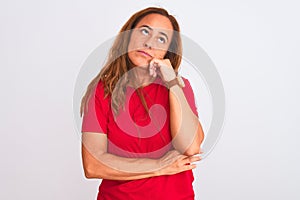 Middle age mature woman standing over white isolated background with hand on chin thinking about question, pensive expression