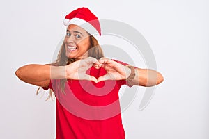 Middle age mature woman wearing christmas hat over isolated background smiling in love doing heart symbol shape with hands