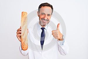 Middle age scientist man holding bread standing over isolated white background happy with big smile doing ok sign, thumb up with