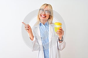 Middle age scientist woman wearing glasses drinking coffee over isolated white background very happy pointing with hand and finger
