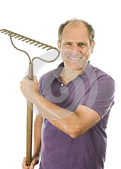 Middle age senior man holding garden bow rake tool