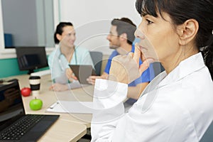 middle age senior nurse doctor woman thinking looking tired