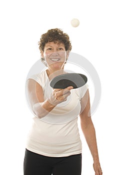 Middle age senior woman playing ping pong