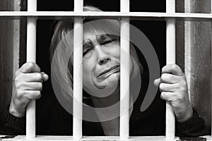 Middle Age Woman Behind Bars photo