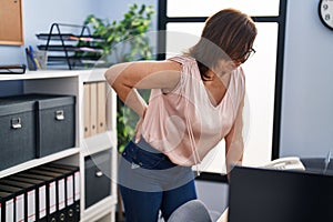 Middle age woman business worker suffering for backache at office